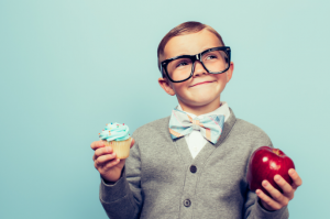 kid trying to decide between apple and cupcake