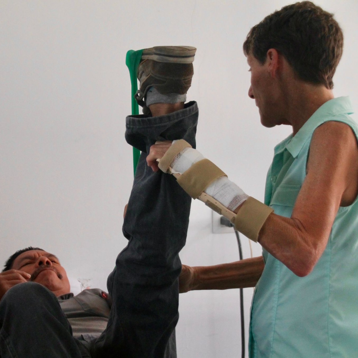 Dr Susanne helps a patient in Guatemala with his exercises